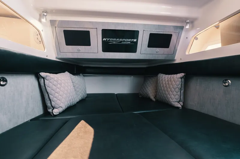 Slide: The Image of Interior cabin of 2018 HCB 53 Suenos boat with cushioned seating and pillows. - 24