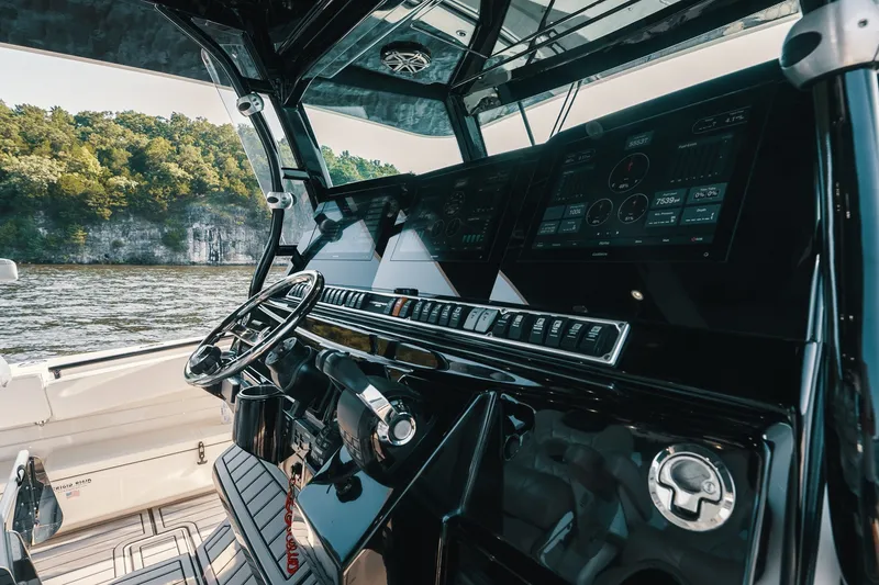 Slide: The Image of Interior view of 2018 HCB 53 Suenos boat cockpit with advanced navigation controls. - 46