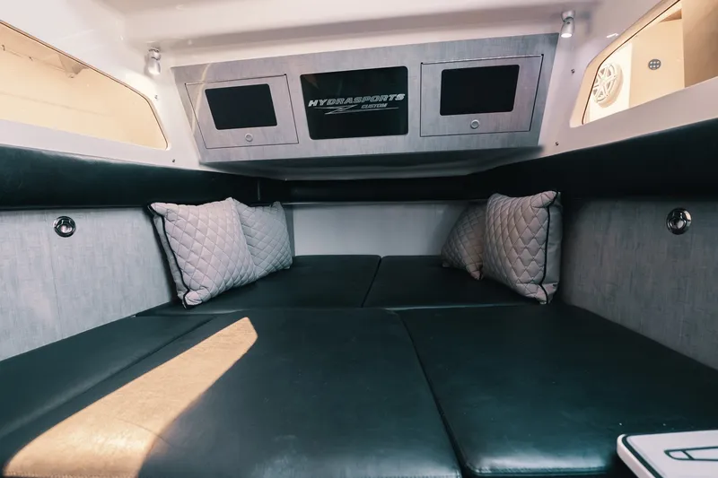 Slide: The Image of Interior cabin of 2018 HCB 53 Suenos boat with cushioned seating and pillows. - 23