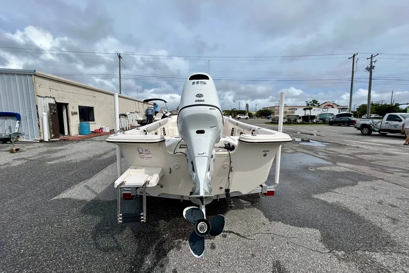 Slide: The Image of 2025 Carolina Skiff 19 LS boat with outboard motor in a parking lot. - 5