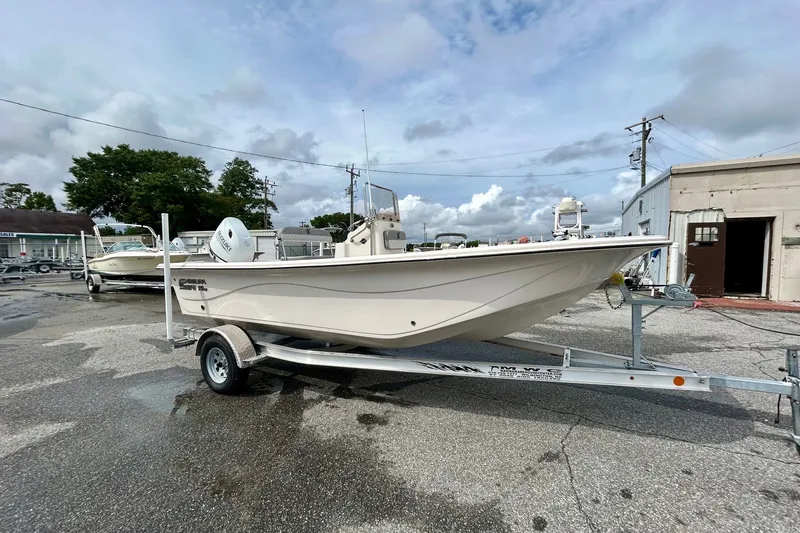 Slide: The Image of 2025 Carolina Skiff 19 LS boat on trailer, parked outdoors under cloudy sky. - 3