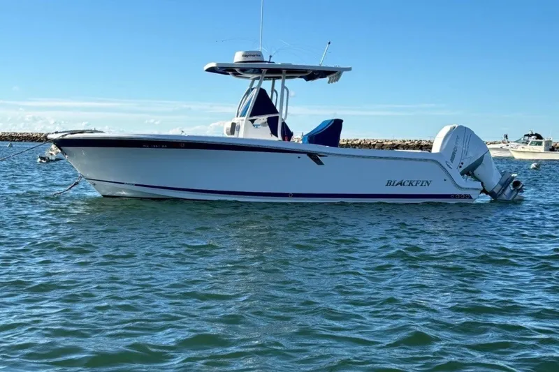 The Image of 2019 Blackfin 242 CC boat on calm water, side view, clear sky background. - 1