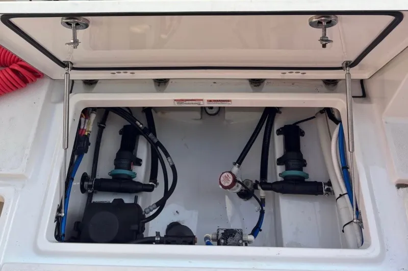 Slide: The Image of Open hatch of 2019 Blackfin 242 CC boat showing internal wiring and components. - 5