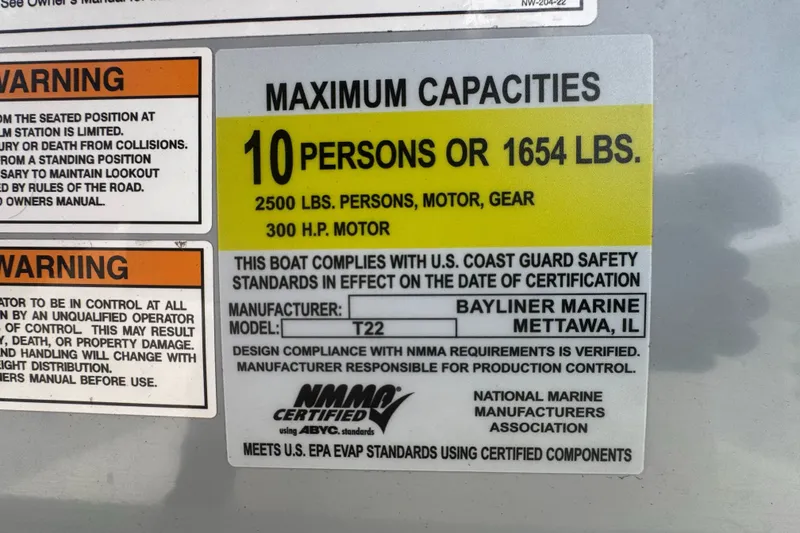 Slide: The Image of Warning label on Trophy CC22 boat, 2023 model, showing maximum capacities and safety compliance. - 8