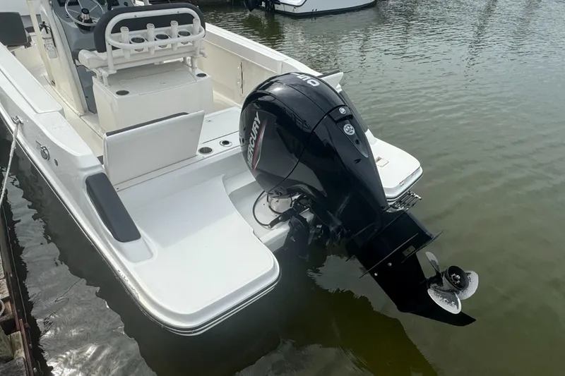 Slide: The Image of 2023 Trophy CC22 boat with Mercury outboard motor docked on calm water. - 7
