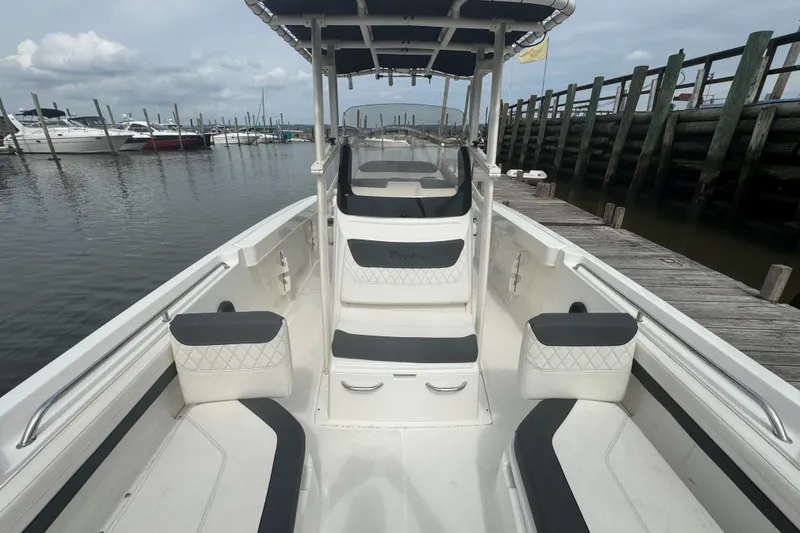 Slide: The Image of 2023 Trophy CC22 boat docked at marina, showcasing spacious seating and sleek design. - 5