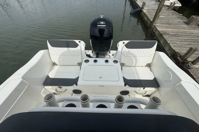 Slide: The Image of 2023 Trophy CC22 boat with seating and outboard motor at dockside. - 6