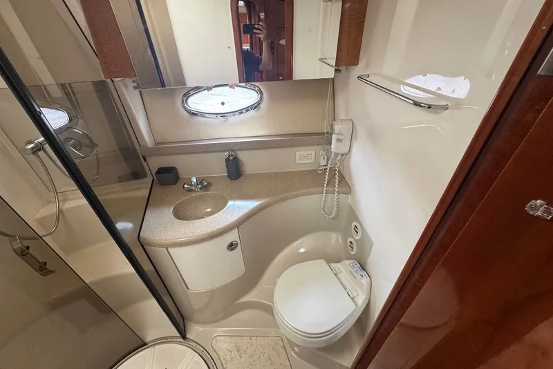 Slide: The Image of Luxurious bathroom in 2004 Regal Commodore 3860 yacht with modern fixtures and porthole window. - 20