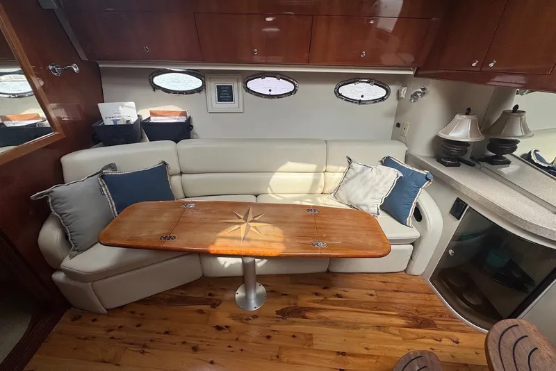 Slide: The Image of Luxurious interior of 2004 Regal Commodore 3860 yacht with elegant seating and wooden table. - 17