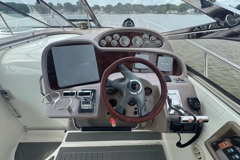Slide: The Image of Cockpit of 2004 Regal Commodore 3860 yacht with steering wheel and navigation instruments. - 10