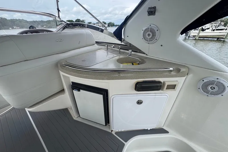 Slide: The Image of 2004 Regal Commodore 3860 yacht interior with kitchenette and seating area. - 13