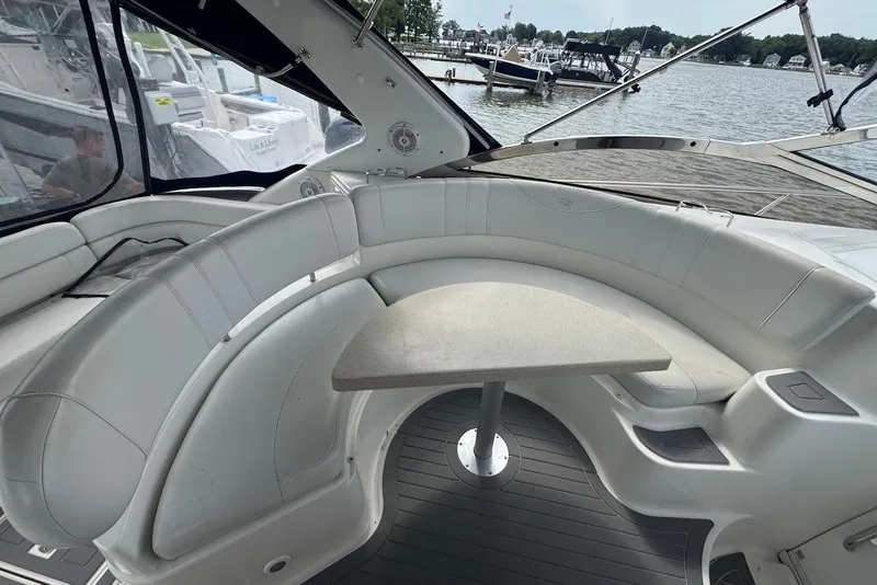 Slide: The Image of Luxurious 2004 Regal Commodore 3860 yacht interior with curved seating and table, docked by the water. - 11