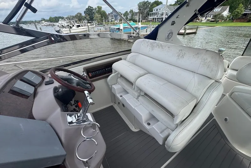 Slide: The Image of 2004 Regal Commodore 3860 boat interior with steering wheel and white seating. - 9