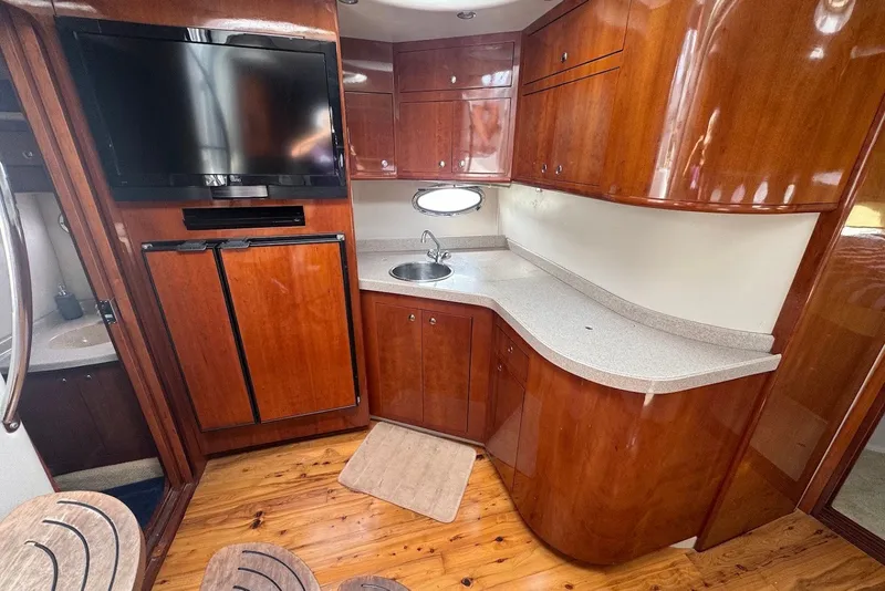 Slide: The Image of Luxurious 2004 Regal Commodore 3860 yacht interior with wood cabinetry and modern amenities. - 15