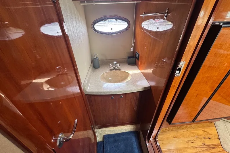 Slide: The Image of Luxurious bathroom interior of 2004 Regal Commodore 3860 yacht with wooden cabinetry. - 16