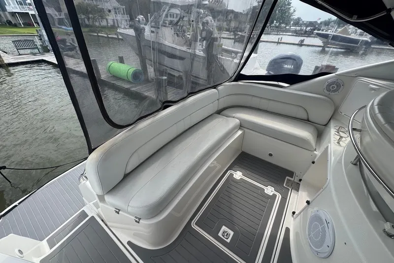 Slide: The Image of 2004 Regal Commodore 3860 yacht interior with cushioned seating and waterfront view. - 12