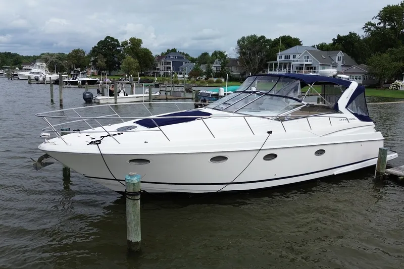 Slide: The Image of 2004 Regal Commodore 3860 yacht docked at a marina, surrounded by waterfront homes. - 1