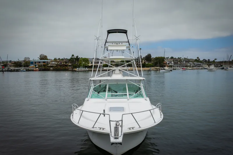 Slide: The Image of 2007 Cabo 31 Express boat docked in a serene marina setting. - 58