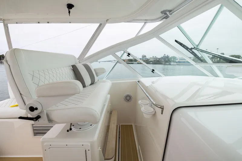 Slide: The Image of Luxurious interior of 2007 Cabo 31 Express boat with white seating and scenic water view. - 13