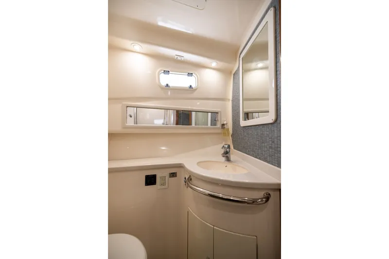 Slide: The Image of Luxurious bathroom interior of 2007 Cabo 31 Express yacht with modern fixtures and mirror. - 41
