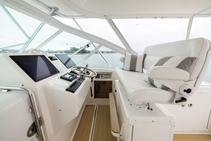 Slide: The Image of Helm of 2007 Cabo 31 Express boat with modern controls and plush seating. - 7
