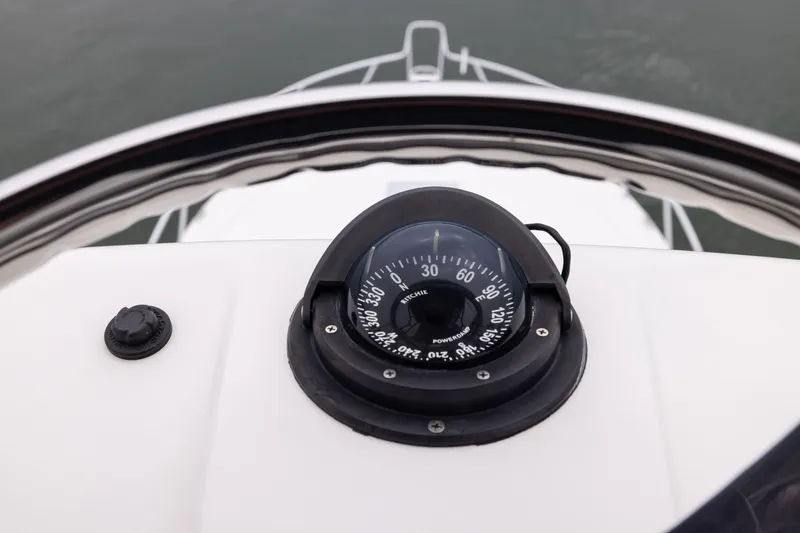 Slide: The Image of Compass on 2007 Cabo 31 Express boat dashboard, overlooking the bow at sea. - 21