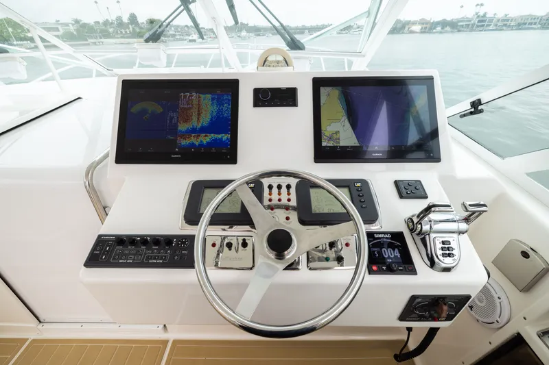 Slide: The Image of Helm of 2007 Cabo 31 Express boat with advanced navigation displays and controls. - 8