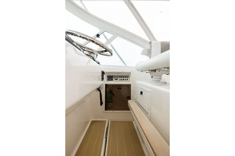 Slide: The Image of Interior view of 2007 Cabo 31 Express boat cockpit with steering wheel and controls. - 12