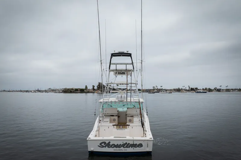 Slide: The Image of 2007 Cabo 31 Express boat on calm water, overcast sky, rear view. - 49