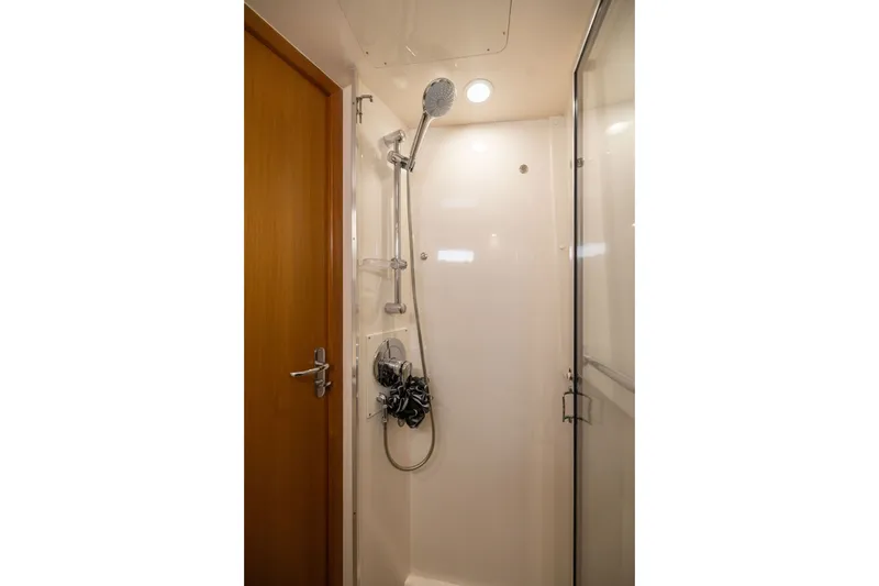 Slide: The Image of Shower area in 2007 Cabo 31 Express boat, featuring modern fixtures and wooden door. - 44