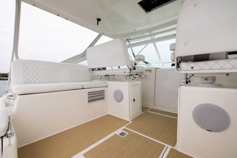 Slide: The Image of 2007 Cabo 31 Express boat interior with white seating and modern design. - 5