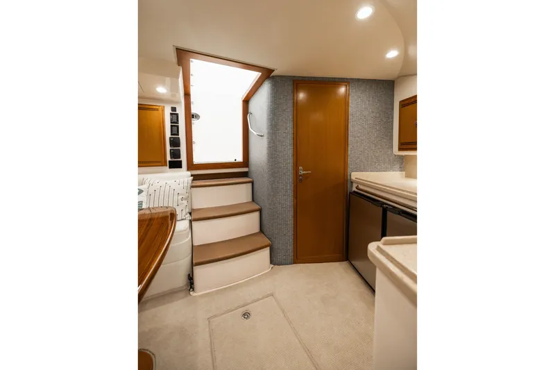 Slide: The Image of Interior of 2007 Cabo 31 Express yacht with stairs, door, and kitchenette. - 28