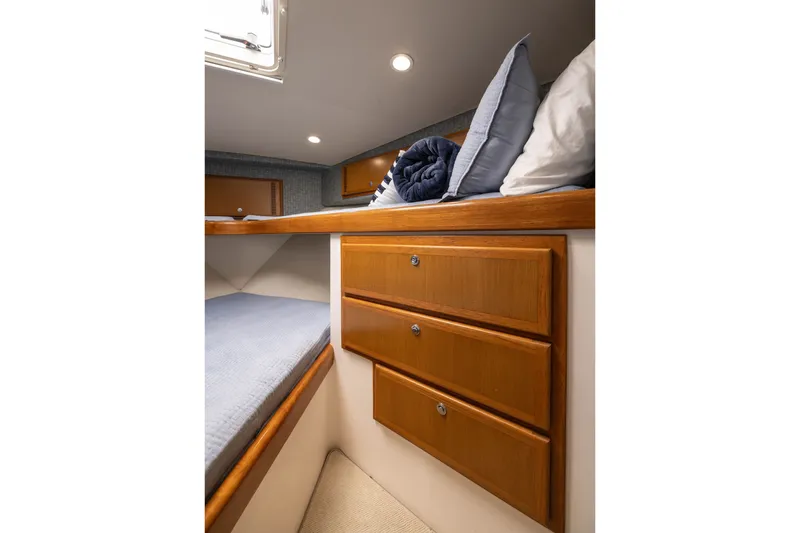 Slide: The Image of Interior cabin of 2007 Cabo 31 Express boat with wooden drawers and cozy bedding. - 39