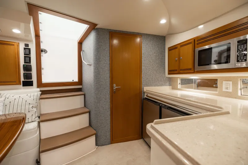 Slide: The Image of Interior of 2007 Cabo 31 Express yacht with modern kitchen and wooden cabinetry. - 27