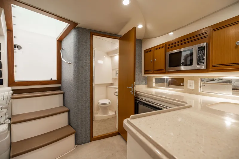 Slide: The Image of Luxurious 2007 Cabo 31 Express yacht interior with kitchenette and bathroom. - 29