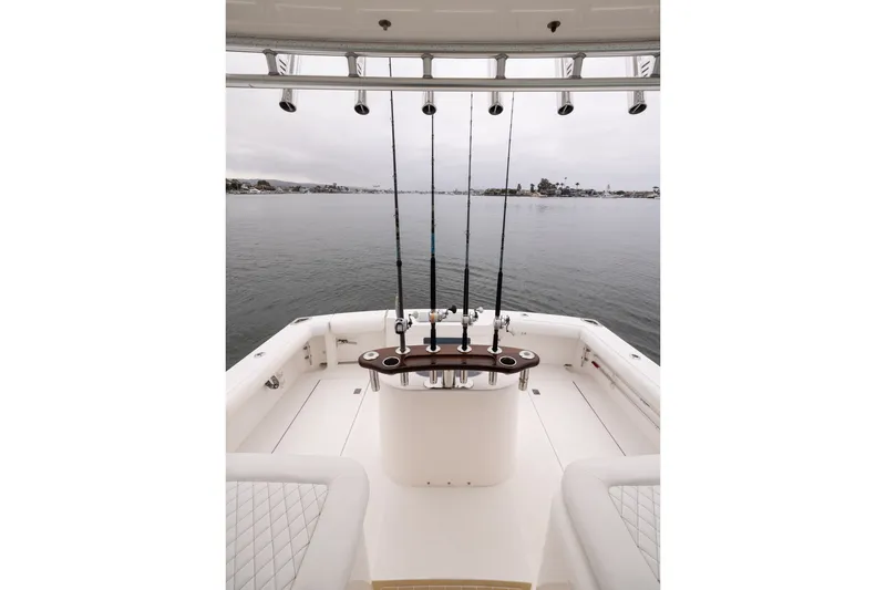 Slide: The Image of 2007 Cabo 31 Express fishing boat with rods, on calm water. - 15