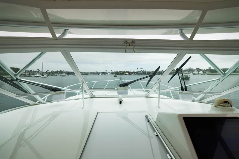 Slide: The Image of View from the helm of a 2007 Cabo 31 Express boat in a marina. - 14