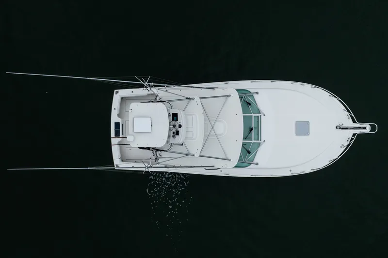 Slide: The Image of Aerial view of 2007 Cabo 31 Express boat on dark water. - 55
