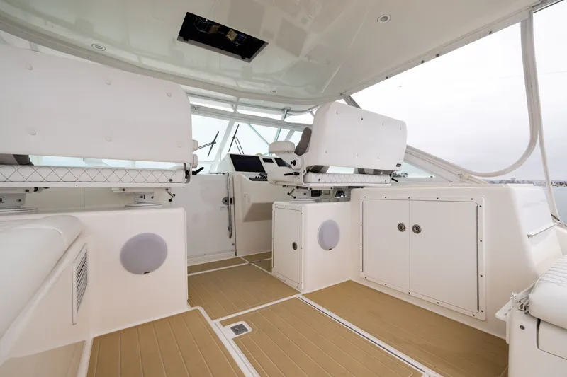 Slide: The Image of 2007 Cabo 31 Express boat interior with white seating and modern controls. - 1