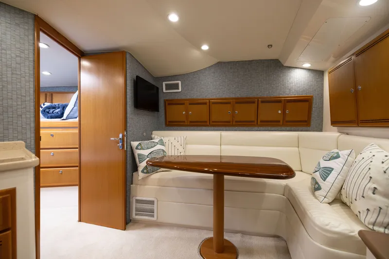 Slide: The Image of Luxurious interior of a 2007 Cabo 31 Express yacht with cozy seating and wooden cabinetry. - 34