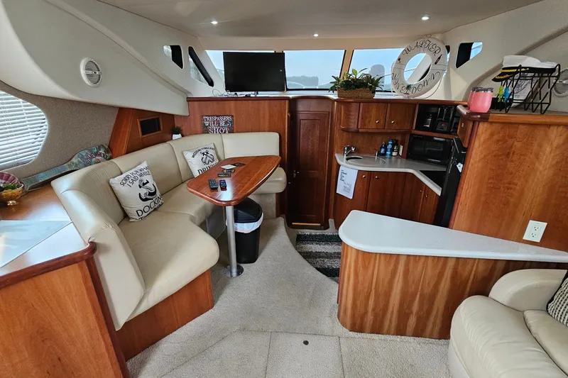 Slide: The Image of Interior of 2003 Silverton 35 Motor Yacht with cozy seating and wooden cabinetry. - 17
