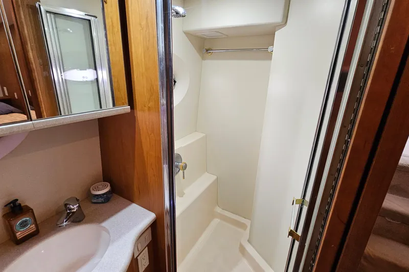 Slide: The Image of 2003 Silverton 35 Motor Yacht bathroom with shower and sink area. - 31