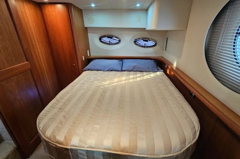 Slide: The Image of Luxurious cabin interior of 2003 Silverton 35 Motor Yacht with cozy bed and wooden accents. - 27