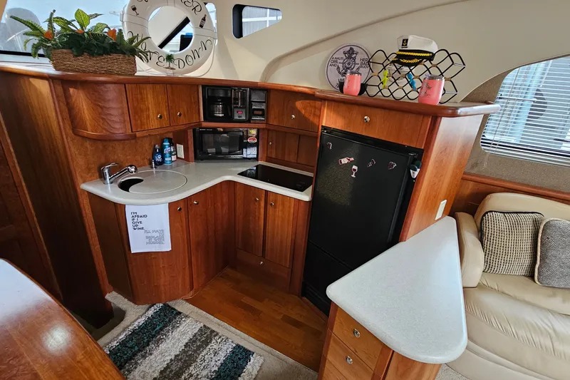 Slide: The Image of Interior of 2003 Silverton 35 Motor Yacht with wooden cabinetry and modern amenities. - 19