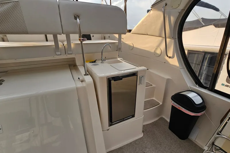 Slide: The Image of 2003 Silverton 35 Motor Yacht interior with sink, mini-fridge, and steps. - 8