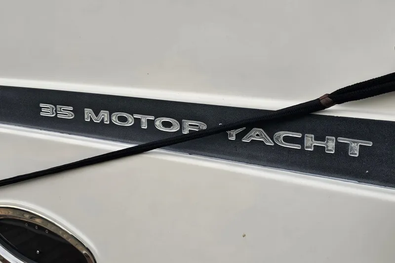 Slide: The Image of 2003 Silverton 35 Motor Yacht nameplate with a black rope across it. - 32