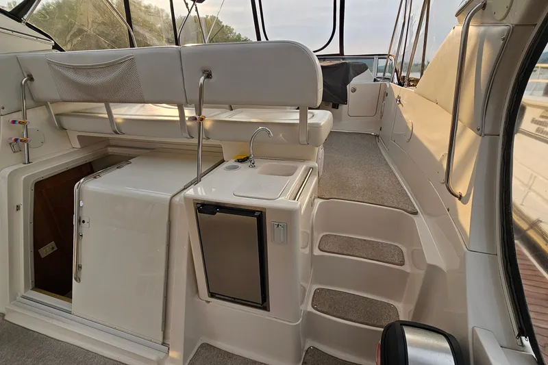 Slide: The Image of 2003 Silverton 35 Motor Yacht interior with kitchenette and seating area. - 9