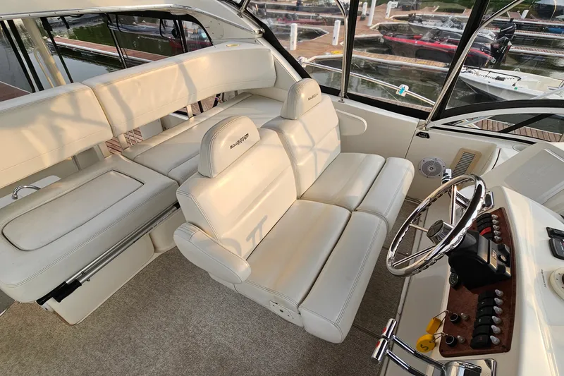 Slide: The Image of Interior of 2003 Silverton 35 Motor Yacht with plush seating and steering wheel. - 13