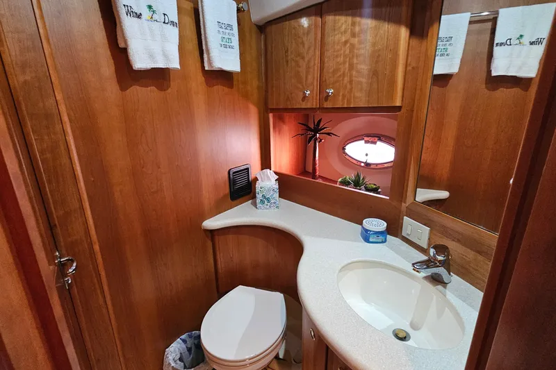 Slide: The Image of Bathroom interior of 2003 Silverton 35 Motor Yacht with wooden cabinetry and modern fixtures. - 25