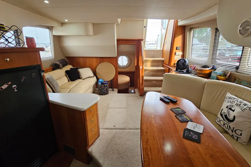 Slide: The Image of Interior of 2003 Silverton 35 Motor Yacht with cozy seating and wooden table. - 22